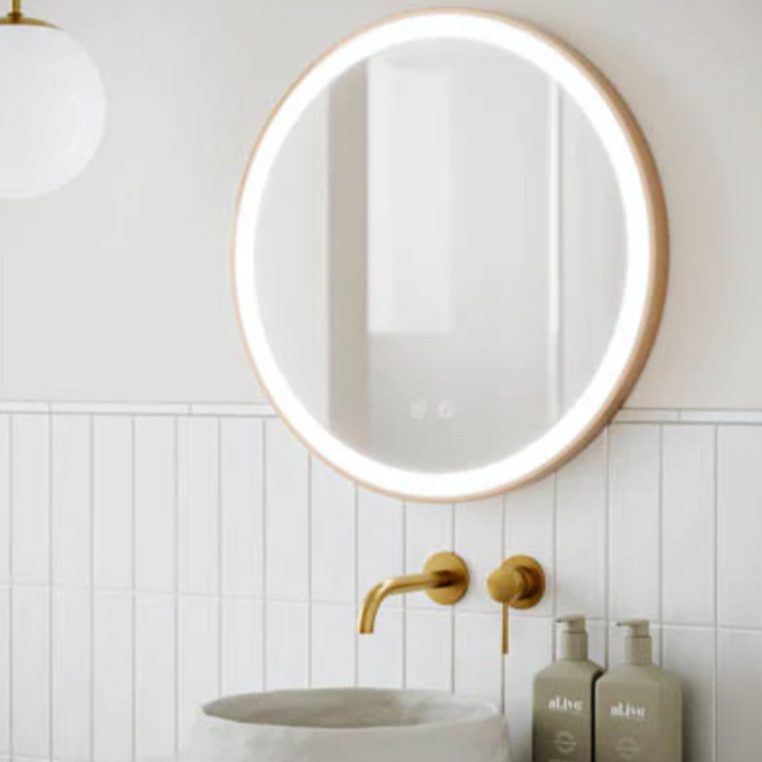 Light bright bathroom with gold mirror
