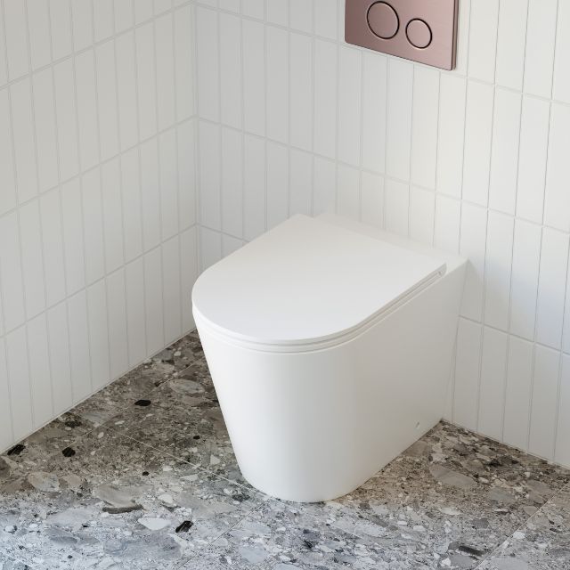 Bao Elegant Matte White Rimless Toilet Suite with behind the wall cistern featuring Nero flush plate and buttons in Brushed Bronze