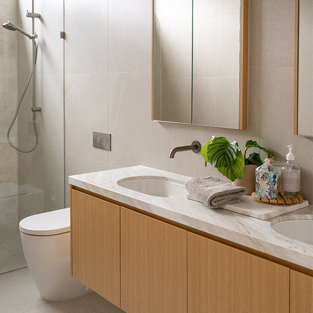 Caroma Liano brushed nickel taps, accessories and Urbane II Cleanflush toilet suite | Timberline shaving cabinet | Modern Bathroom Renovation | The Blue Space