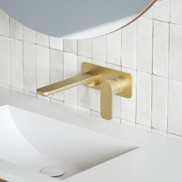 Caroma Luna Lead Free Wall Basin/Bath Mixer Brushed Brass on white textured tile