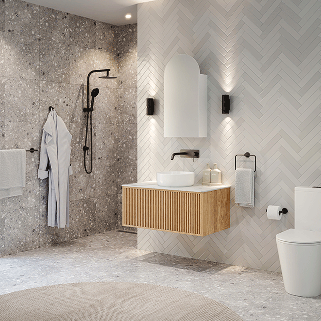 The blue space bathroom package matte black indigo tapware, showers and bathroom accessories. Terrazzo tiles, herringbone tiles. Indigo toilet suite and Ingrain bathroom vanity and shaving cabinet.