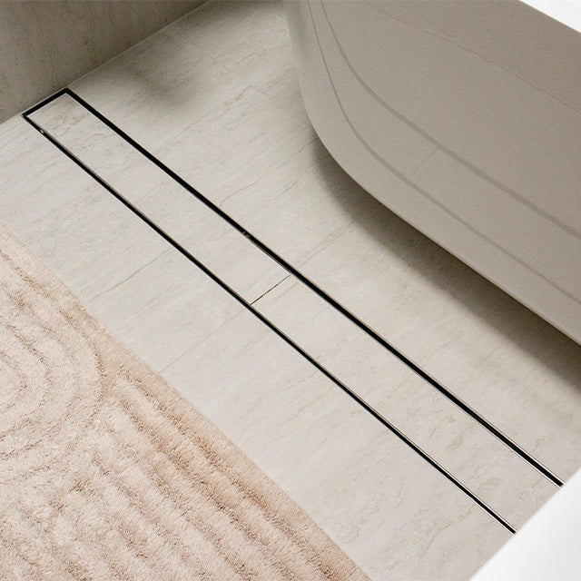 Lifestyle Front Nero Tile Insert V Channel Floor Grate 89mm Outlet With Hole Saw Brushed Gold NRFG001HSBG - The Blue Space