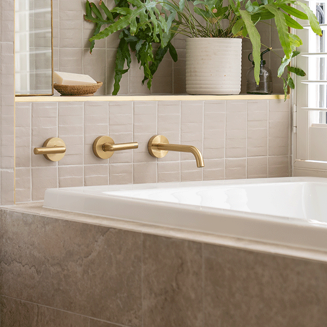 Phoenix Vivid Slimline Plus Lever Wall Top Assemblies Brushed Gold used on bath