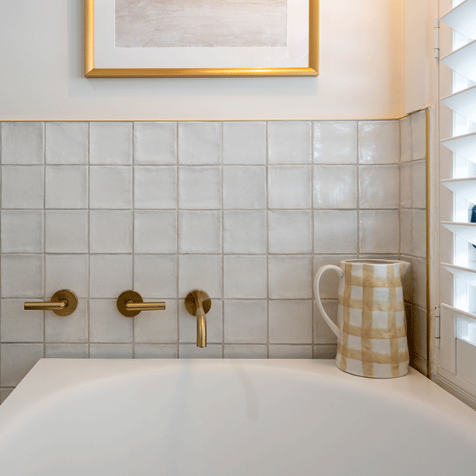 White Dianna Zellige Tile 100 x 100 x 9mm Spanish Ceramic with Phoenix brushed gold lever bath taps and bao corner bath