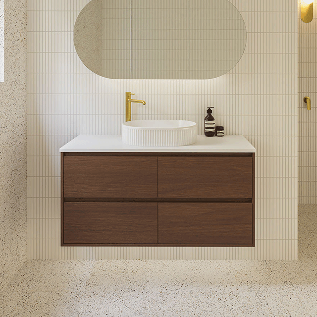 Timberline Grange wall hung vanity with above counter basin included. Dark walnut timber coloured vanity with white top, white fluted basin. Paired with gold taps and kit kat tiles.