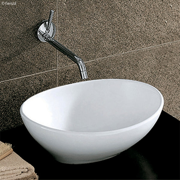Fienza Paola Above Counter Basin with a chrome wall basin outlet on a black vanity top