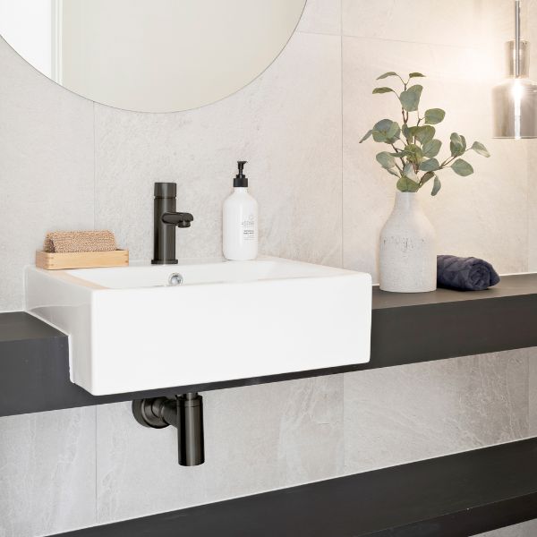 Meir Pinless Round Basin Mixer Shadow finish features bottle trap and round mirror in modern bathroom design - The Blue Space