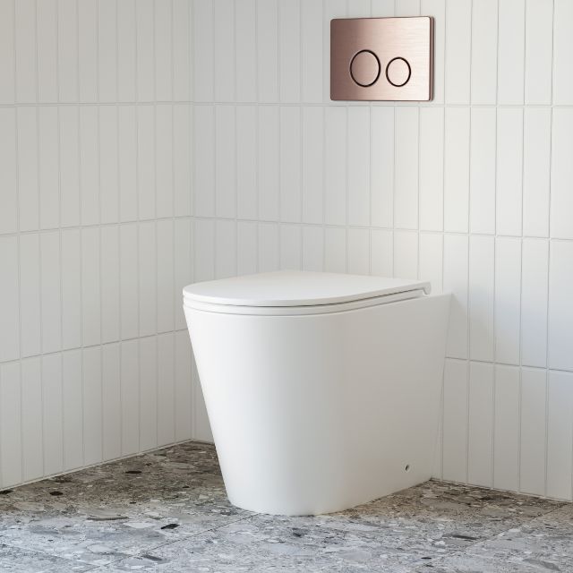 Bao Elegant Matte White Rimless Toilet Suite with behind the wall cistern featuring Nero flush plate and buttons in Brushed Bronze