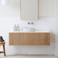 Ingrain Ash Grooved Timber Wall Hung Vanity 1200mm in breezy, neutral bathroom. Featuring brushed nickel tapware, Nood Co. Mill basin in Morning Mist, Ingrain LED shaving cabinet and Calacatta White sintered stone benchtop. Available exclusively from The Blue Space.