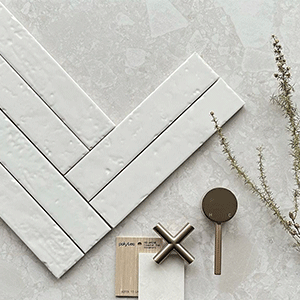 Rippled white subway tiles layered on a white terrazzo tile | Shop Tiles at The Blue Space