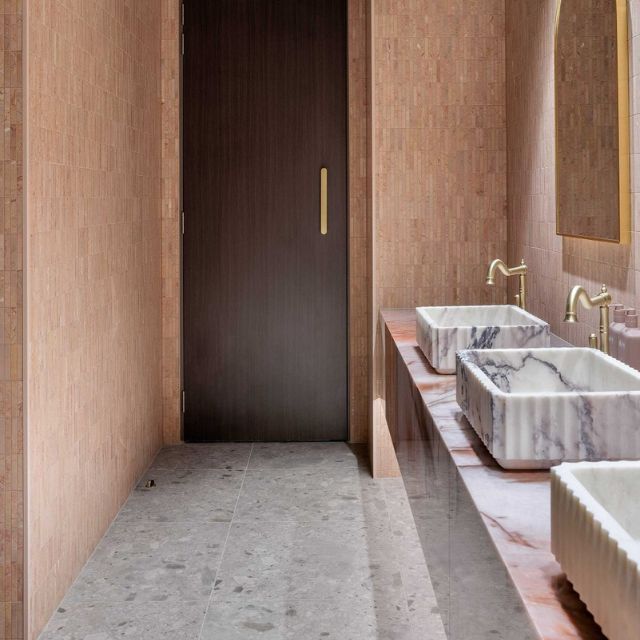 Zanda Duke 330mm Pull Handle in Satin Gold on walnut door with terracotta tiles in bathroom