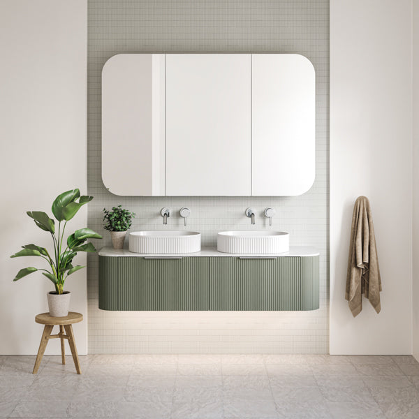 Timberline Santos Curved Vanity 1500 Double bowl with fluted front in Satin Olive. Pictured with Oval Fluted basins, chrome tapware and accessories and natural coloured bathroom - The Blue Space