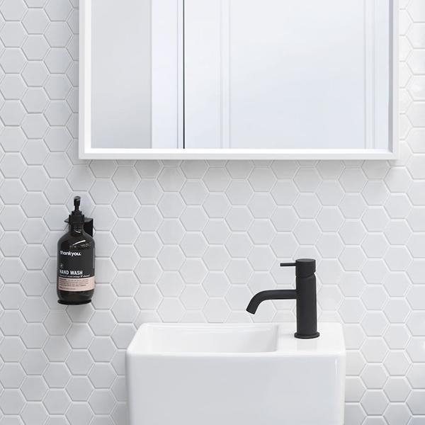 Clark Round Pin Bathroom Basin Mixer - Matte Black tap in modern bathroom with small hand wall basin- The Blue Space