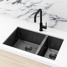 Meir Single Bowl PVD Kitchen Sink 670mm - Gunmetal Black Featured on a White Kitchen Benchtop and Marble Splashback with a Squared Off Sink Mixer - The Blue Space