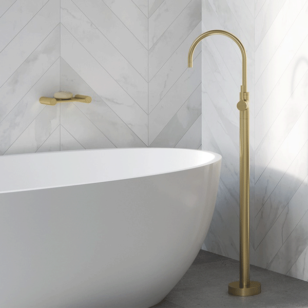 Phoenix Vivid Slimline Oval Floor Mounted Bath Mixer-Brushed Gold - Brushed brass floor mixer in white textured bathroom