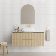 Marquis Lake Wall Hung Vanity 1200mm centre basin in prime oak finish, Symphony Blanco top, glass white basin, brushed brass towel handle and basin mixer features arch mirror in modern bathroom design - The Blue Space